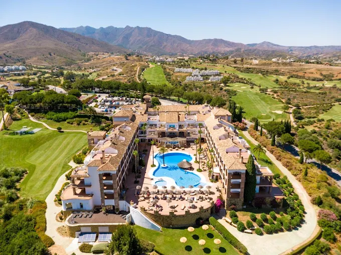 Blick von oben auf das Golfhotel La Cala Resort mit Golfplätzen und Landschaft im Hintergrund